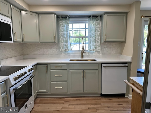 475 Ruffian Ct, Annapolis, MD 21409 - kitchen featuring white appliances, a sink, gray cabinets, light wood-style flooring, and light stone countertops