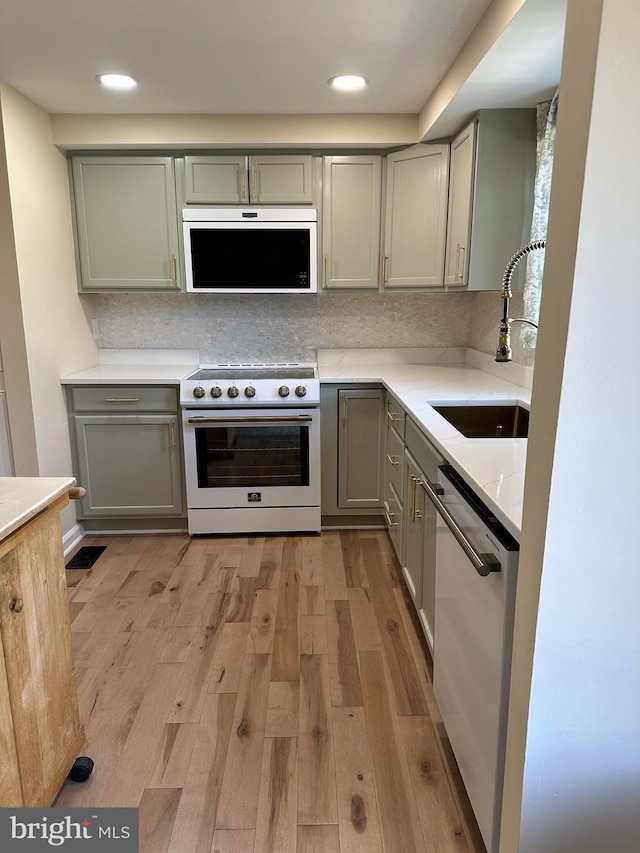 475 Ruffian Ct, Annapolis, MD 21409 - kitchen featuring range with gas stovetop, gray cabinetry, a sink, dishwashing machine, and light wood-type flooring