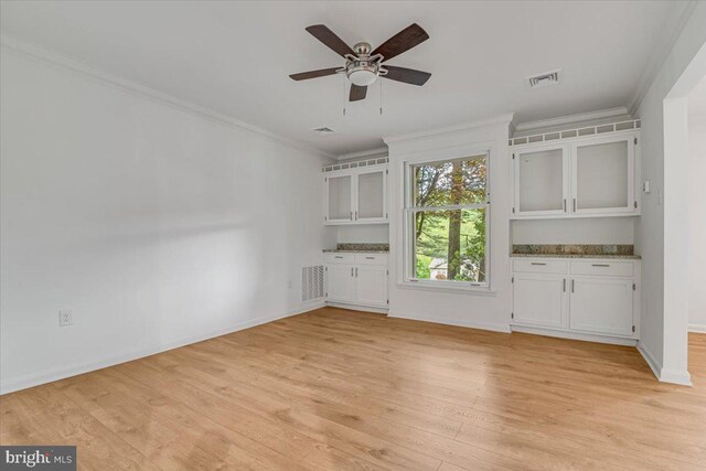 711 E Center St, Nesquehoning, PA 18240 - unfurnished living room with crown molding, light wood-style flooring, ceiling fan, and baseboards