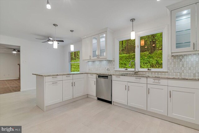 711 E Center St, Nesquehoning, PA 18240 - kitchen featuring stainless steel dishwasher, a sink, a ceiling fan, a peninsula, and decorative backsplash