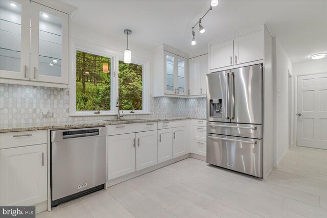 711 E Center St, Nesquehoning, PA 18240 - kitchen with stainless steel appliances, a sink, tasteful backsplash, white cabinetry, and light stone counters