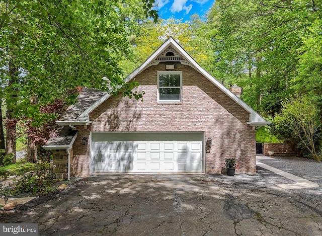 711 E Center St, Nesquehoning, PA 18240 - view of front of house with asphalt driveway, brick siding, a chimney, and a garage