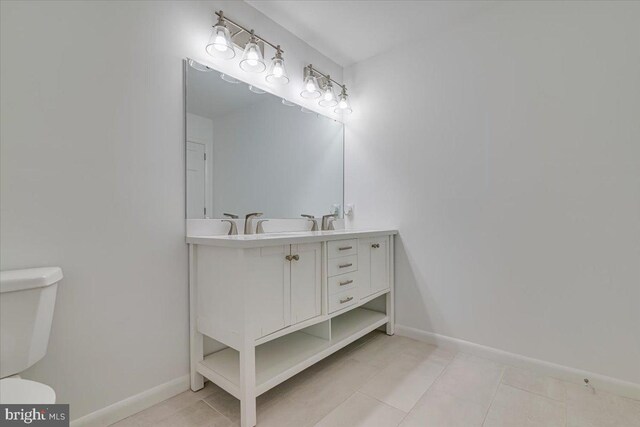 711 E Center St, Nesquehoning, PA 18240 - bathroom with toilet, double vanity, baseboards, and tile patterned floors