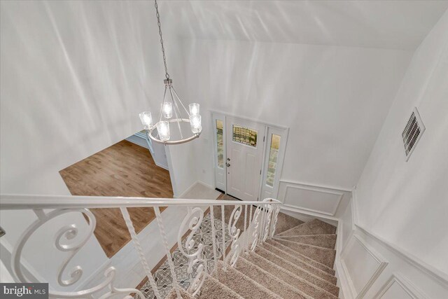 711 E Center St, Nesquehoning, PA 18240 - stairs featuring a chandelier, a decorative wall, and a wainscoted wall