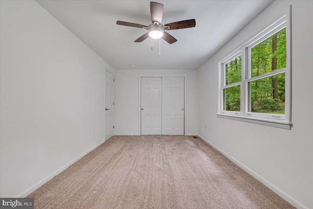 711 E Center St, Nesquehoning, PA 18240 - unfurnished bedroom featuring light carpet, baseboards, a closet, and ceiling fan