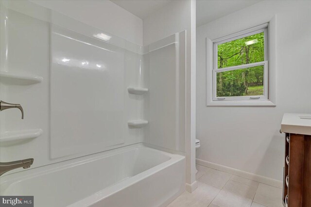 711 E Center St, Nesquehoning, PA 18240 - full bath featuring toilet, vanity, baseboards, tile patterned flooring, and  shower combination