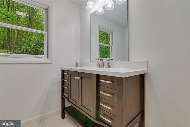 711 E Center St, Nesquehoning, PA 18240 - bathroom with vanity, plenty of natural light, baseboards, and tile patterned floors