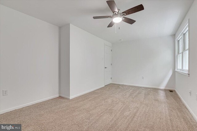 711 E Center St, Nesquehoning, PA 18240 - empty room featuring light carpet, ceiling fan, and baseboards