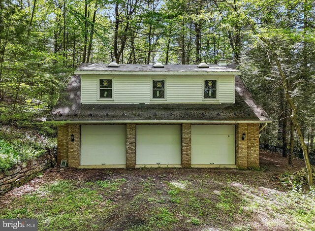 711 E Center St, Nesquehoning, PA 18240 - view of front of home with brick siding, a garage, and a chimney