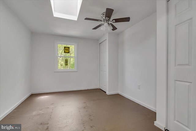 711 E Center St, Nesquehoning, PA 18240 - unfurnished room with concrete floors, baseboards, a ceiling fan, and a skylight