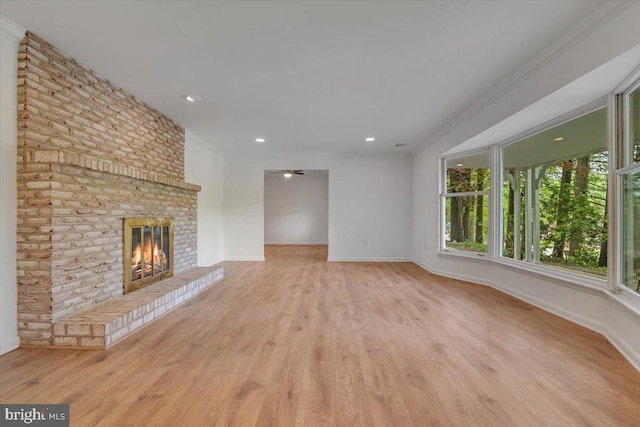 711 E Center St, Nesquehoning, PA 18240 - unfurnished living room featuring wood finished floors, a brick fireplace, baseboards, recessed lighting, and crown molding