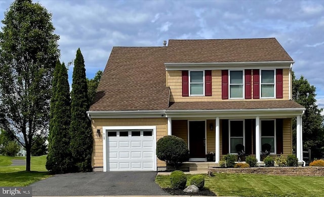 2127 Gable Ln, Quakertown, PA 18951 - view of front facade with a porch, a front yard, driveway, and roof with shingles