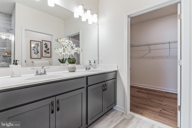706 Aldora Dr Harper, Unit Harper, Aberdeen, MD 21001 - bathroom featuring double vanity, an enclosed shower, a walk in closet, and baseboards