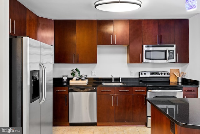 157 Fleet St Unit 1006, Oxon Hill, MD 20745 - kitchen with stainless steel appliances, a sink, dark stone countertops, and light tile patterned floors
