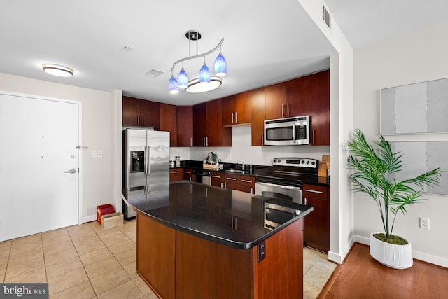 157 Fleet St Unit 1006, Oxon Hill, MD 20745 - kitchen with appliances with stainless steel finishes, dark countertops, a sink, and hanging light fixtures