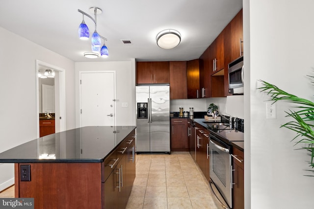 157 Fleet St Unit 1006, Oxon Hill, MD 20745 - kitchen with appliances with stainless steel finishes, a center island, light tile patterned floors, a sink, and pendant lighting