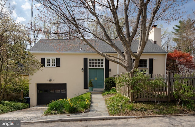 121 Hilltop Rd, Philadelphia, PA 19118 - view of front of house featuring stucco siding, a garage, concrete driveway, a chimney, and a shingled roof