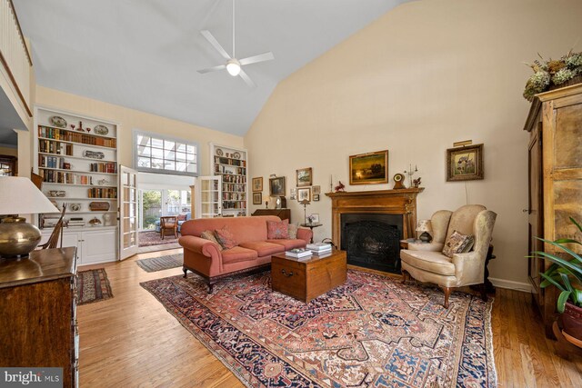 121 Hilltop Rd, Philadelphia, PA 19118 - living area with high vaulted ceiling, a fireplace, a ceiling fan, light wood-style floors, and built in features