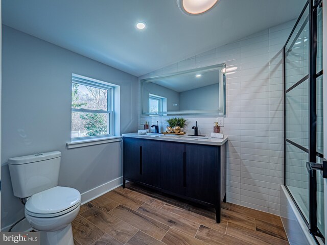 58 Park Ave, Hamilton, NJ 08690 - bathroom with toilet, wood tiled floors, lofted ceiling, double vanity, and enclosed tub / shower combo