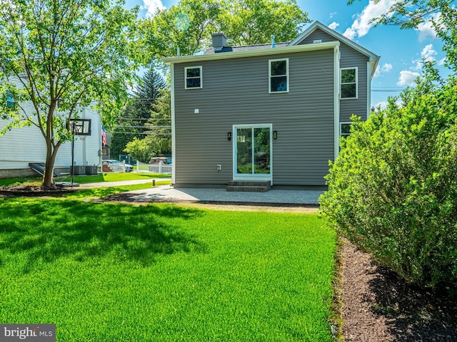 58 Park Ave, Hamilton, NJ 08690 - back of house featuring a patio area, a lawn, and a chimney