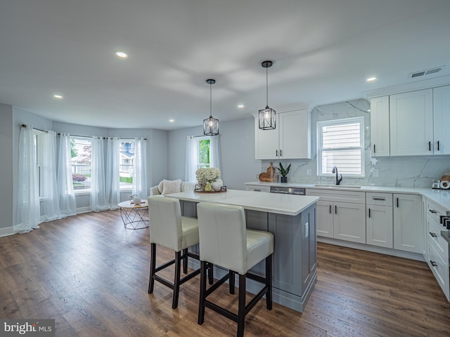 58 Park Ave, Hamilton, NJ 08690 - kitchen featuring a sink, a kitchen island, recessed lighting, a kitchen breakfast bar, and decorative backsplash