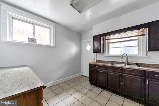 7252 Brent Rd, Upper Darby, PA 19082 - kitchen featuring a sink, baseboards, dark brown cabinetry, and light tile patterned floors