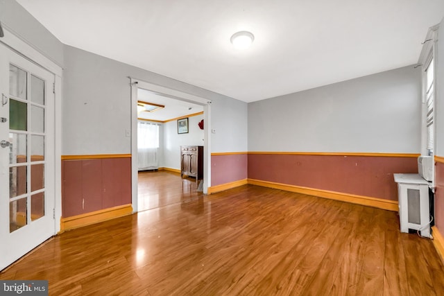 7252 Brent Rd, Upper Darby, PA 19082 - spare room featuring wood finished floors, a wainscoted wall, and baseboards