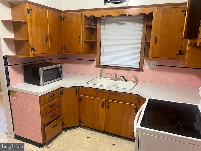 511 Passmore Ave, Hammonton, NJ 08037 - kitchen featuring open shelves, stainless steel microwave, a sink, white range with electric stovetop, and tasteful backsplash