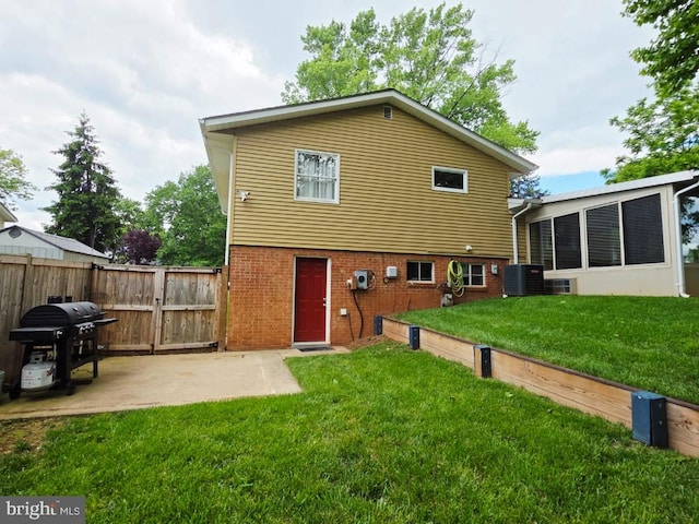 402 W Maple Ave, Sterling, VA 20164 - back of house with a gate, central air condition unit, brick siding, and a patio