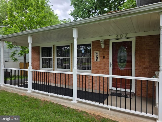 402 W Maple Ave, Sterling, VA 20164 - view of exterior entry with covered porch and brick siding