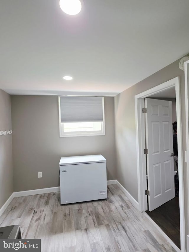 402 W Maple Ave, Sterling, VA 20164 - empty room with light wood-style flooring, baseboards, and a smoke detector