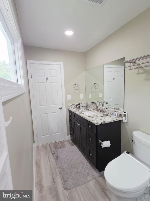 402 W Maple Ave, Sterling, VA 20164 - bathroom featuring wood finished floors, vanity, toilet, and recessed lighting