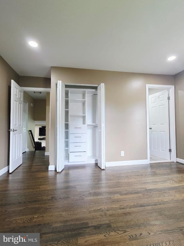 402 W Maple Ave, Sterling, VA 20164 - unfurnished bedroom with baseboards, dark wood-type flooring, recessed lighting, and a closet