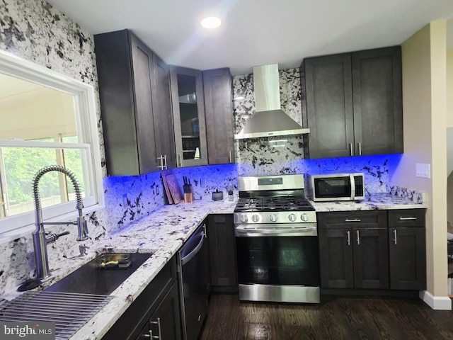 402 W Maple Ave, Sterling, VA 20164 - kitchen featuring stainless steel appliances, wall chimney range hood, a sink, and dark wood finished floors