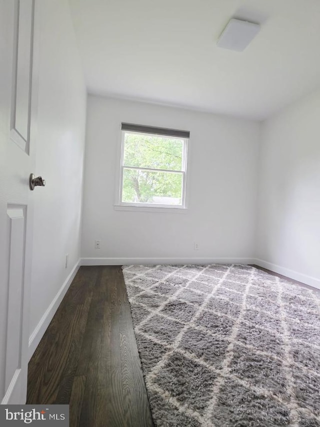 402 W Maple Ave, Sterling, VA 20164 - spare room featuring dark wood-style floors and baseboards