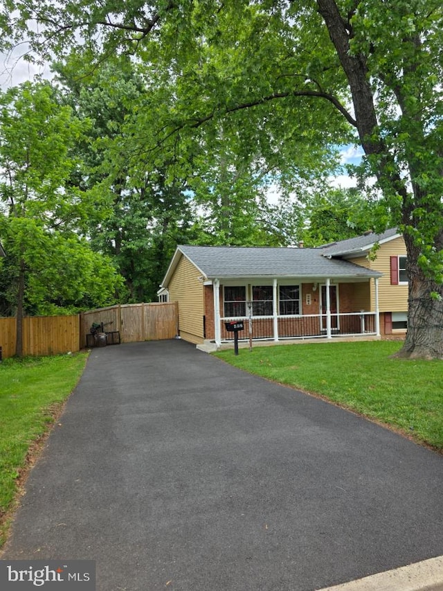 402 W Maple Ave, Sterling, VA 20164 - split level home featuring a porch, brick siding, asphalt driveway, roof with shingles, and a gate