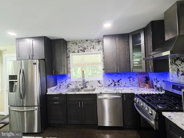 402 W Maple Ave, Sterling, VA 20164 - kitchen with stainless steel appliances, wall chimney exhaust hood, a sink, light stone countertops, and recessed lighting