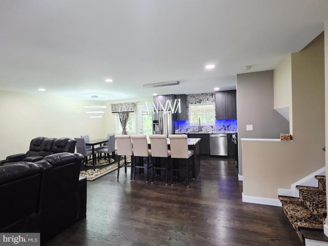 402 W Maple Ave, Sterling, VA 20164 - living area featuring dark wood-type flooring, recessed lighting, a chandelier, baseboards, and stairs