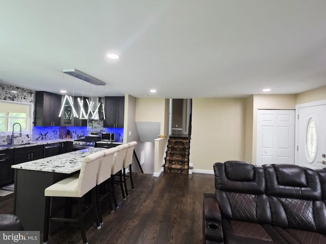 402 W Maple Ave, Sterling, VA 20164 - living room featuring dark wood-type flooring, stairs, recessed lighting, and baseboards