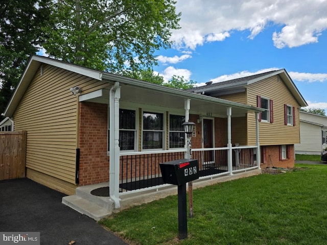 402 W Maple Ave, Sterling, VA 20164 - view of front facade featuring a porch, brick siding, and a front lawn