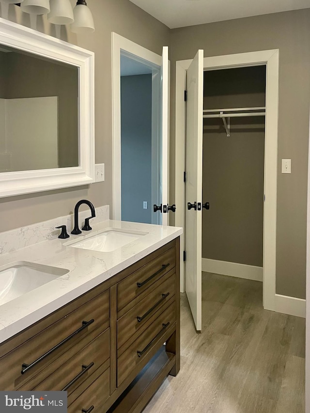 211 Workman Dr, Keyser, WV 26726 - full bath with wood finished floors, double vanity, a spacious closet, and baseboards