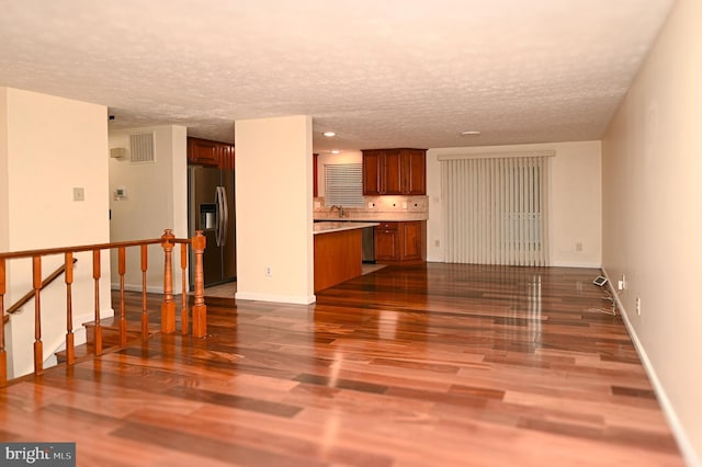8110 Winter Blue Ct, Springfield, VA 22153 - unfurnished living room featuring a textured ceiling, dark wood finished floors, baseboards, a sink, and recessed lighting