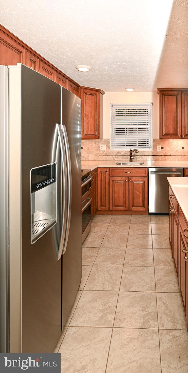 8110 Winter Blue Ct, Springfield, VA 22153 - kitchen with appliances with stainless steel finishes, light countertops, a sink, and backsplash