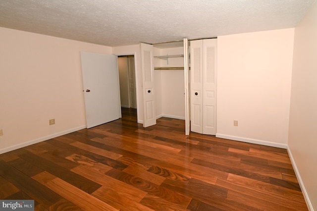 8110 Winter Blue Ct, Springfield, VA 22153 - unfurnished bedroom with multiple closets, wood finished floors, baseboards, and a textured ceiling