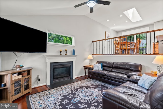 3195 Atlee Ridge Rd, New Windsor, MD 21776 - living area with a skylight, vaulted ceiling, a fireplace with flush hearth, a ceiling fan, and wood finished floors