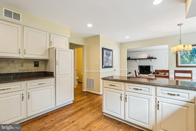 10127 Hillington Ct, Vienna, VA 22182 - kitchen featuring white cabinetry, backsplash, light wood-type flooring, a chandelier, and recessed lighting