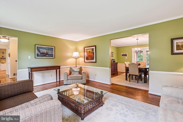 10127 Hillington Ct, Vienna, VA 22182 - living room with wood finished floors, a chandelier, ornamental molding, and baseboards