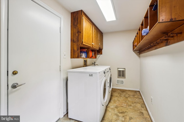 10127 Hillington Ct, Vienna, VA 22182 - laundry area with heating unit, washer and dryer, cabinet space, stone finish flooring, and baseboards