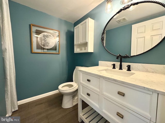 203 Ritter Pl, Berryville, VA 22611 - bathroom featuring wood finished floors, toilet, vanity, and baseboards