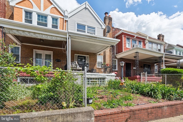 5615 N Warnock St, Philadelphia, PA 19141 - view of property with a porch, brick siding, and a fenced front yard